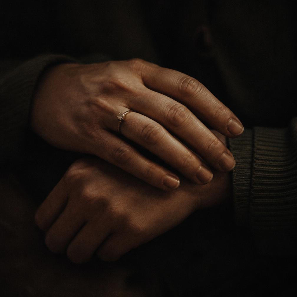 Hands resting in low warm light