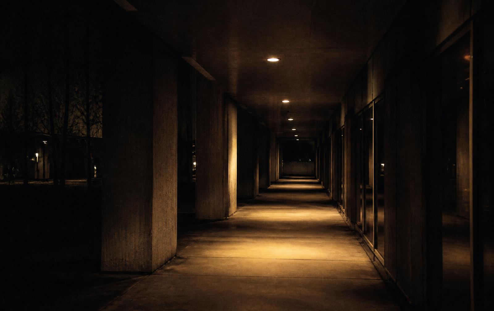 An empty lit corridor at night