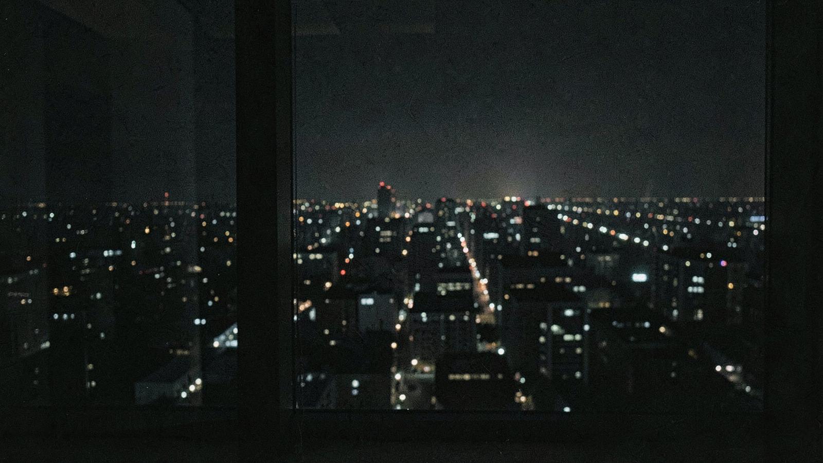 A blurred night city seen through a high office window