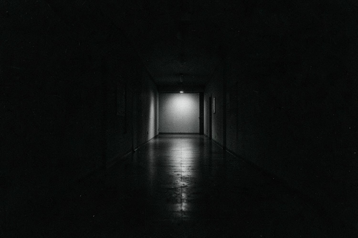 A long empty corridor with soft light at the far end